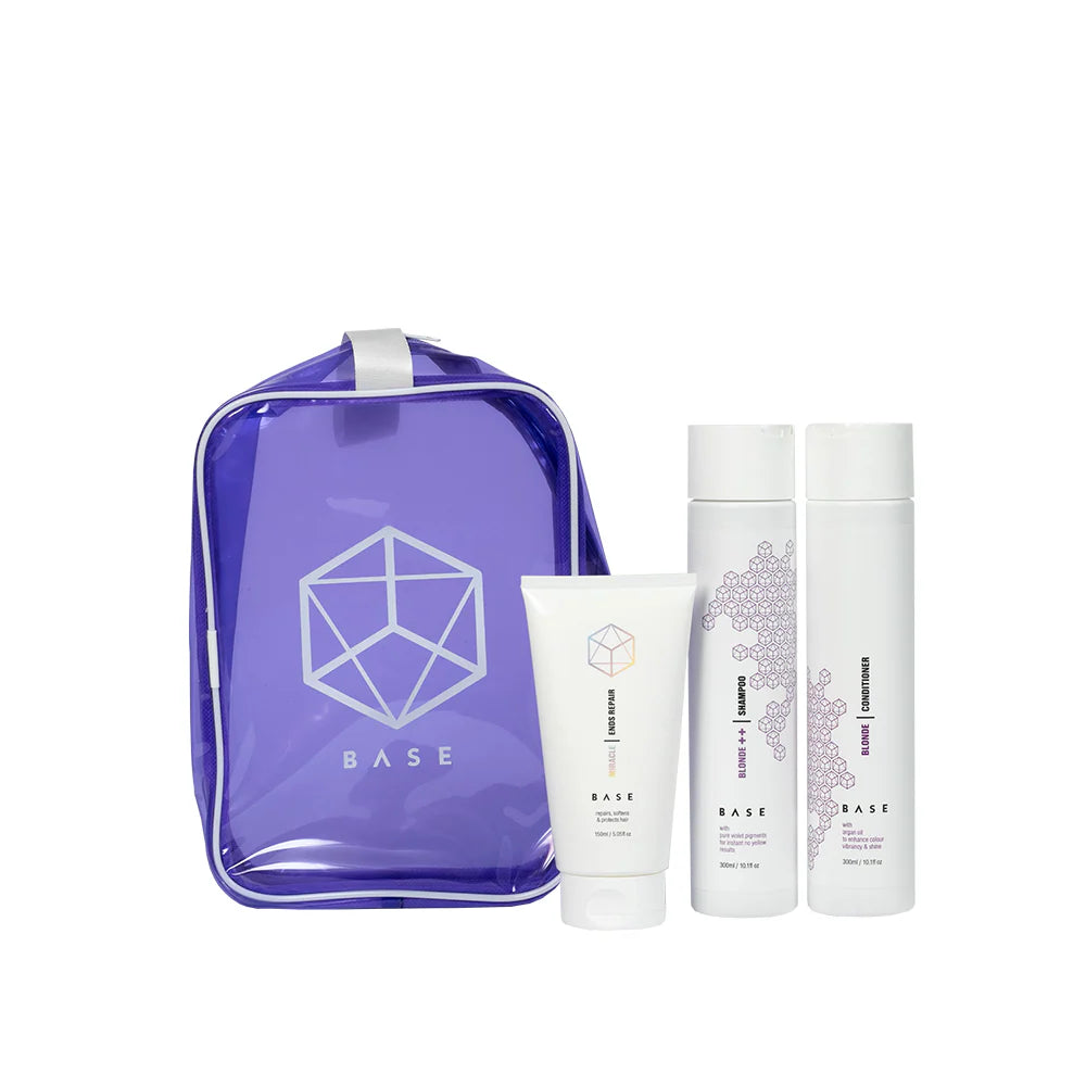 Base Blonde ++ Shampoo, Conditioner, and Miracle Ends Treatment with a purple carrying case on a white background