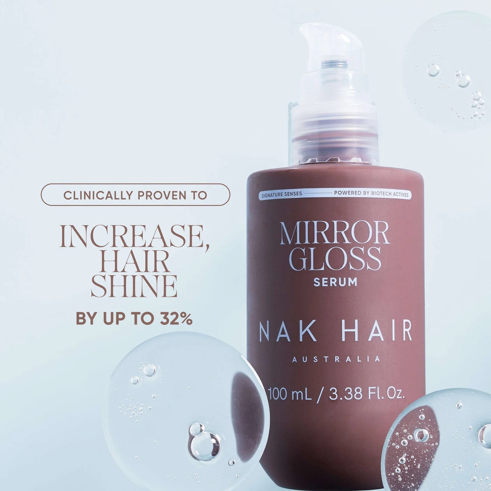 Mirror Gloss Serum for Nak Hair, a 100 mL pump bottle with a frosted cap, set against a light blue background with decorative water droplets and promotional text.