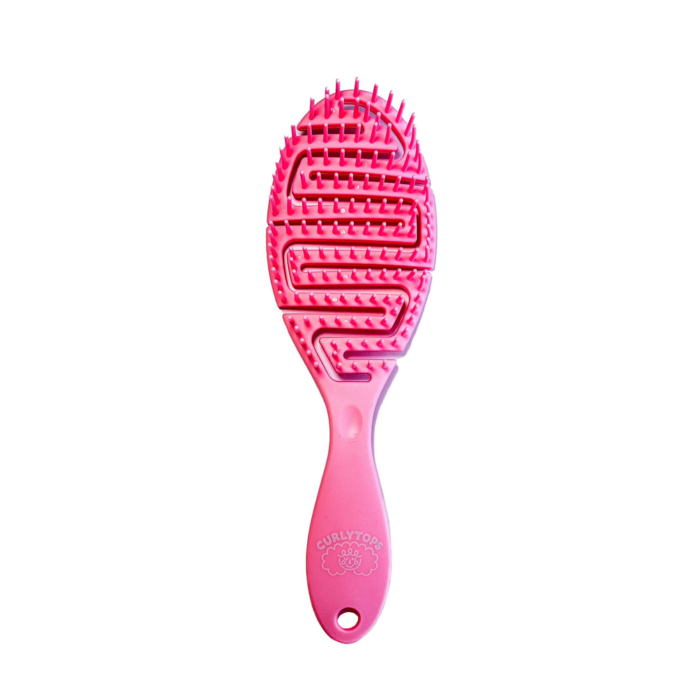 Pink curly hairbrush on a white background