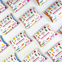 Multiple satin pillowcase packages with colorful designs on a white background