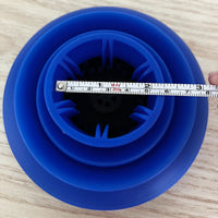 Blue silicone lid with a measuring tape indicating its size on a wooden surface